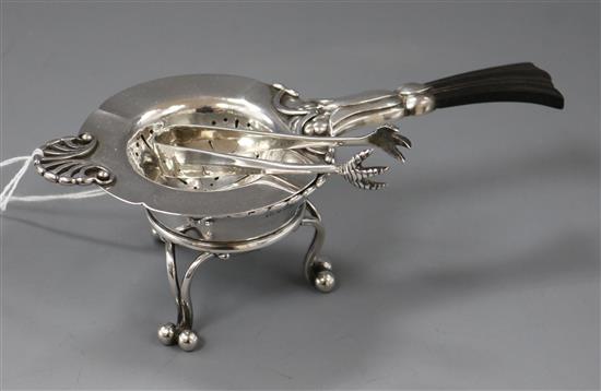 An early 20th century Danish sterling silver tea strainer, a Georg Jensen salt dish and a pair of Georgian silver sugar nips